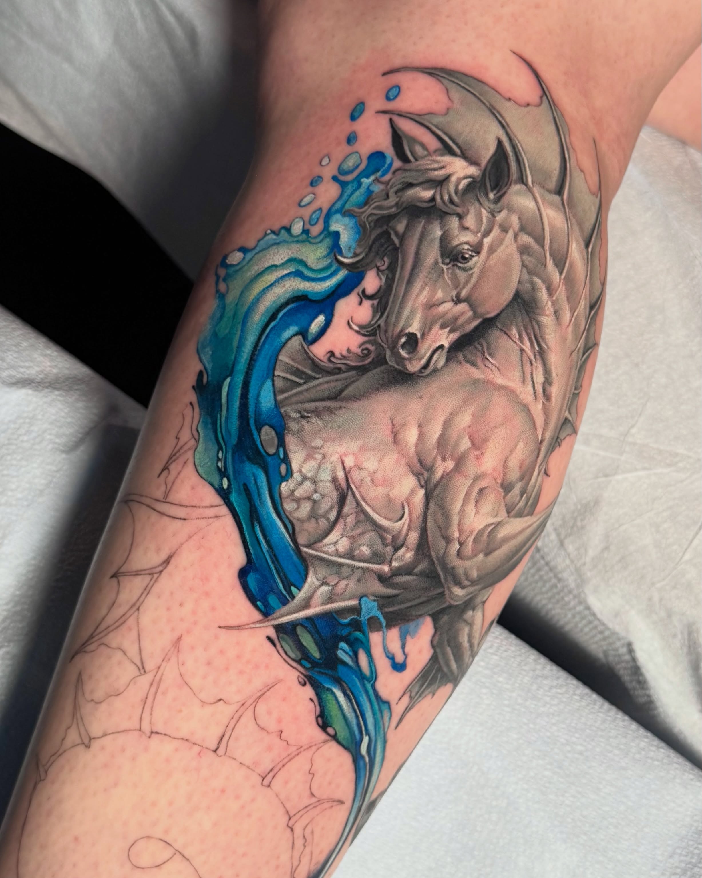 Black-and-grey realism horse tattoo with blue watercolour accents by Julia Luniko in Winnipeg